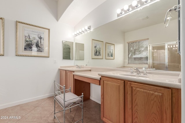 bathroom with vanity, tile patterned floors, walk in shower, and vaulted ceiling