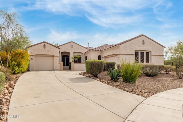 mediterranean / spanish-style home featuring a garage