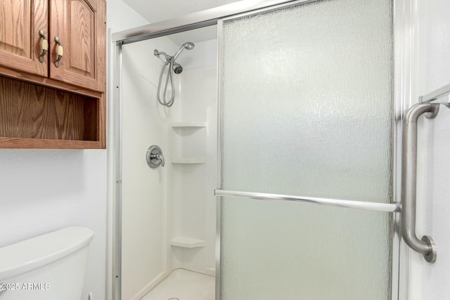 full bathroom with a shower stall and toilet