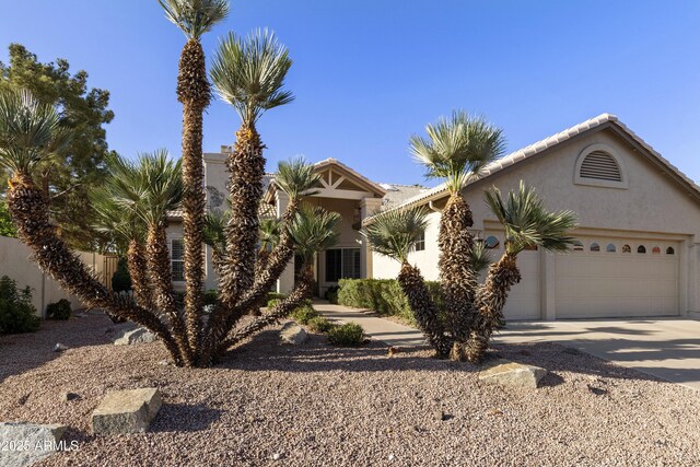 10609 E Cedar Waxwing Dr, Sun Lakes, AZ 85248 - view of front of home featuring a tiled roof, stucco siding, a garage, and concrete driveway