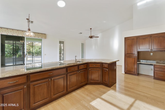 10609 E Cedar Waxwing Dr, Sun Lakes, AZ 85248 - kitchen with vaulted ceiling, a ceiling fan, decorative light fixtures, light wood-style floors, and black electric cooktop