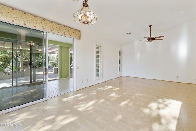 10609 E Cedar Waxwing Dr, Sun Lakes, AZ 85248 - unfurnished room featuring ceiling fan with notable chandelier and vaulted ceiling