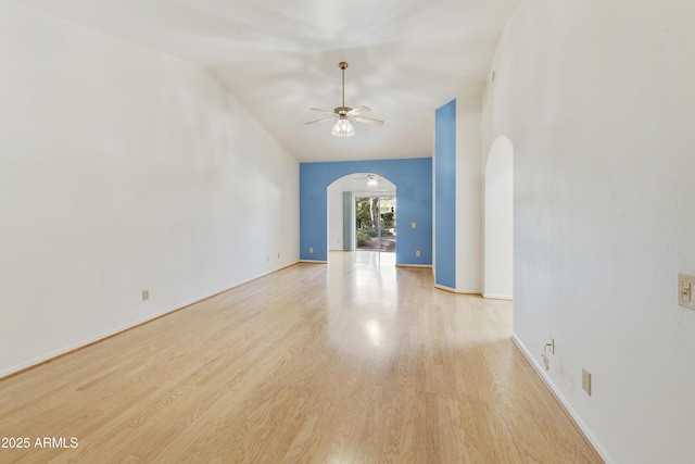 10609 E Cedar Waxwing Dr, Sun Lakes, AZ 85248 - spare room with ceiling fan, arched walkways, wood finished floors, and baseboards