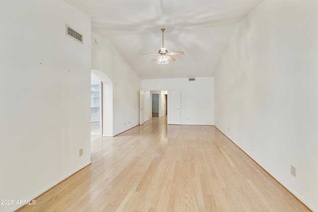 10609 E Cedar Waxwing Dr, Sun Lakes, AZ 85248 - spare room with visible vents, arched walkways, ceiling fan, light wood-type flooring, and lofted ceiling
