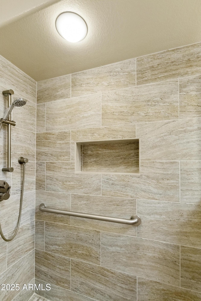 10609 E Cedar Waxwing Dr, Sun Lakes, AZ 85248 - full bathroom featuring a tile shower and a textured ceiling