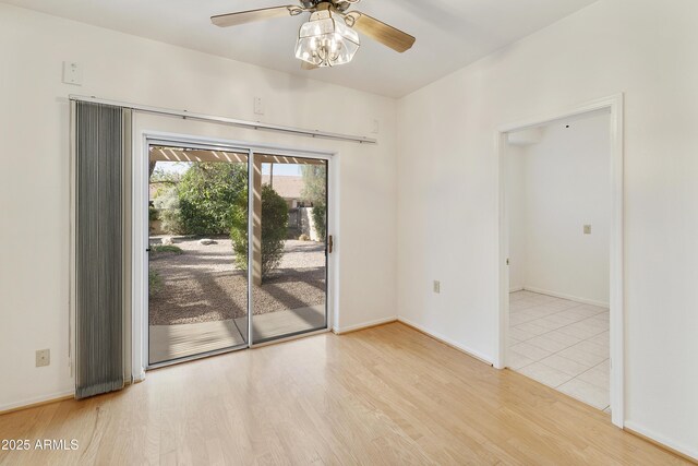 10609 E Cedar Waxwing Dr, Sun Lakes, AZ 85248 - unfurnished room featuring light wood-style flooring, ceiling fan, and baseboards
