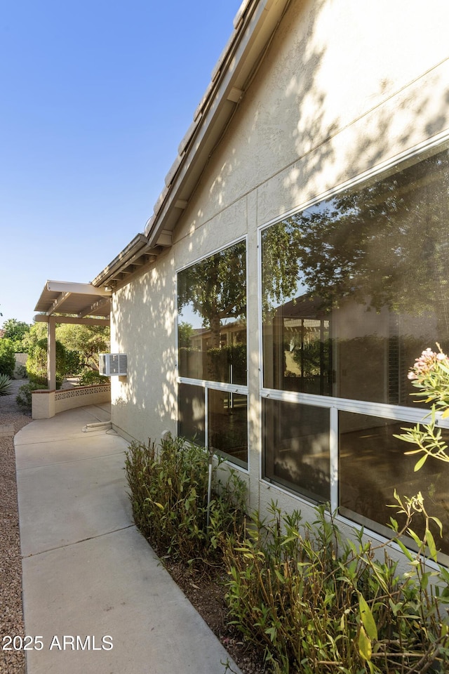10609 E Cedar Waxwing Dr, Sun Lakes, AZ 85248 - view of side of home featuring a patio area and stucco siding