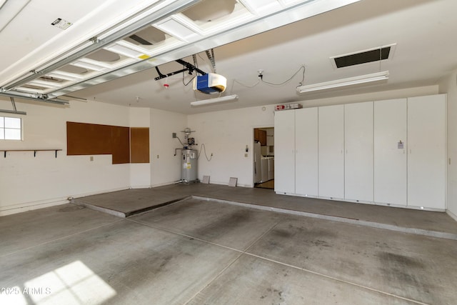 10609 E Cedar Waxwing Dr, Sun Lakes, AZ 85248 - garage featuring water heater, visible vents, and a garage door opener