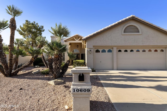 10609 E Cedar Waxwing Dr, Sun Lakes, AZ 85248 - view of front facade with a tiled roof, a garage, stucco siding, and concrete driveway