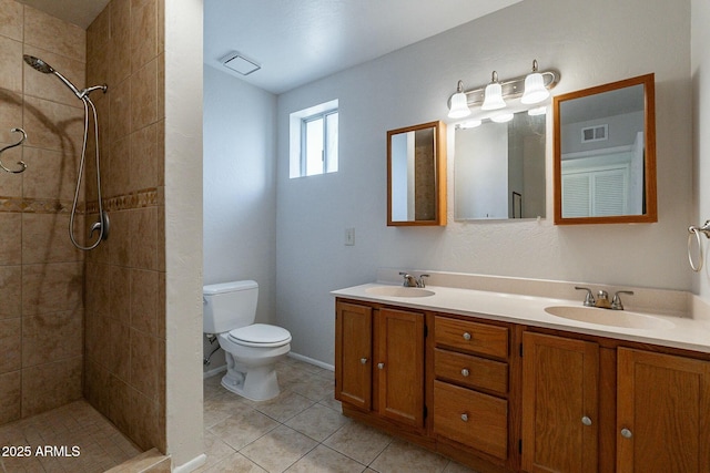 505 W Howe St, Tempe, AZ 85281 - bathroom with double vanity, toilet, a tile shower, and tile patterned flooring