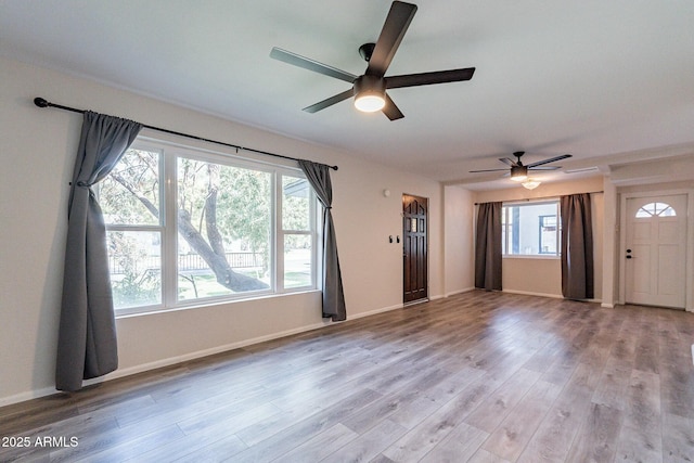 505 W Howe St, Tempe, AZ 85281 - unfurnished living room with ceiling fan, light wood-style flooring, and baseboards