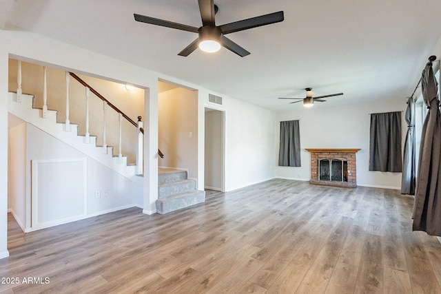 505 W Howe St, Tempe, AZ 85281 - unfurnished living room with a ceiling fan, light wood-style floors, stairs, a fireplace, and baseboards