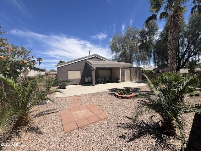 exterior space featuring a patio area, stucco siding, and fence