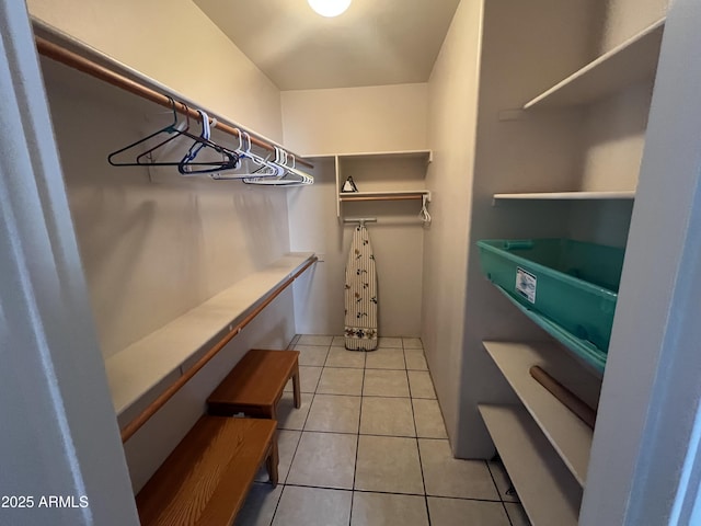 walk in closet with light tile patterned flooring
