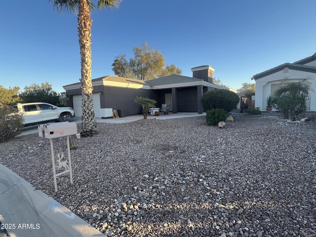 view of front of house featuring stucco siding and a garage