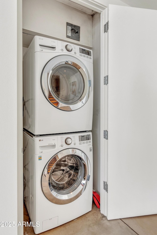 laundry room with stacked washing machine and dryer