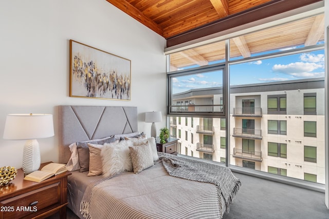 carpeted bedroom featuring wood ceiling and beam ceiling