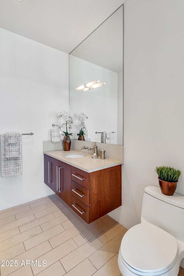 bathroom featuring toilet and vanity