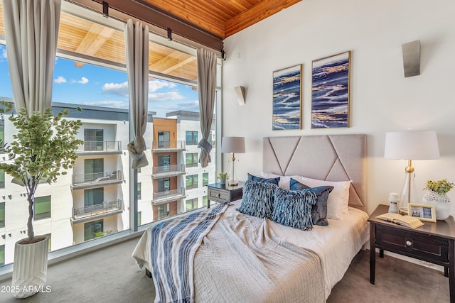 bedroom featuring wood ceiling and carpet floors