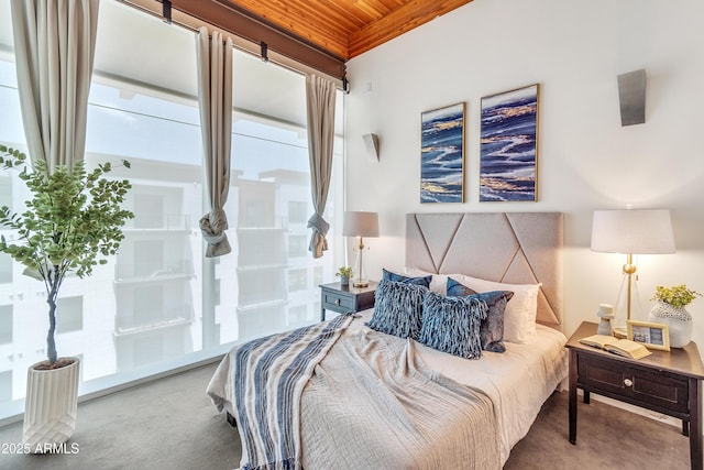 carpeted bedroom with wooden ceiling