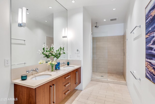 full bathroom featuring a walk in shower, recessed lighting, tile patterned flooring, and double vanity