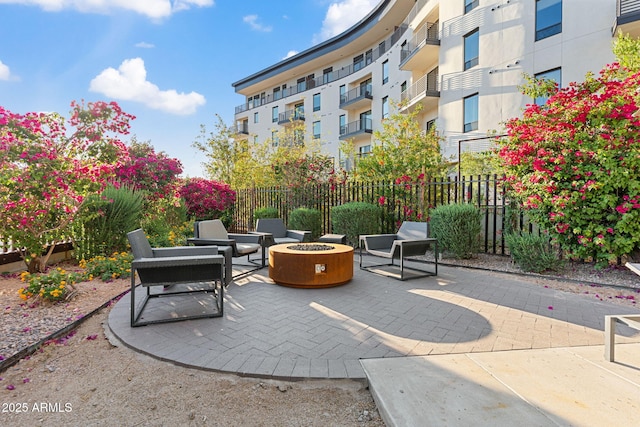 view of patio with a fire pit and fence
