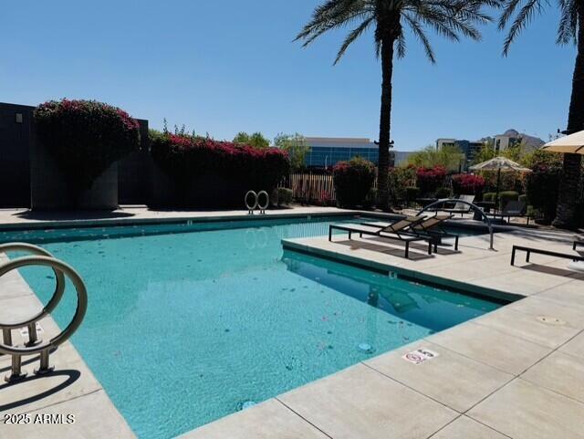 community pool featuring a patio area and fence