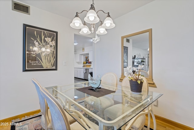 dining space featuring a notable chandelier and hardwood / wood-style floors