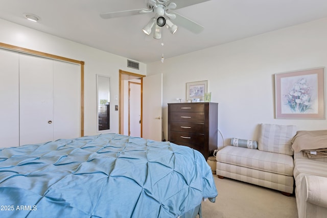 bedroom with light carpet, a closet, and ceiling fan