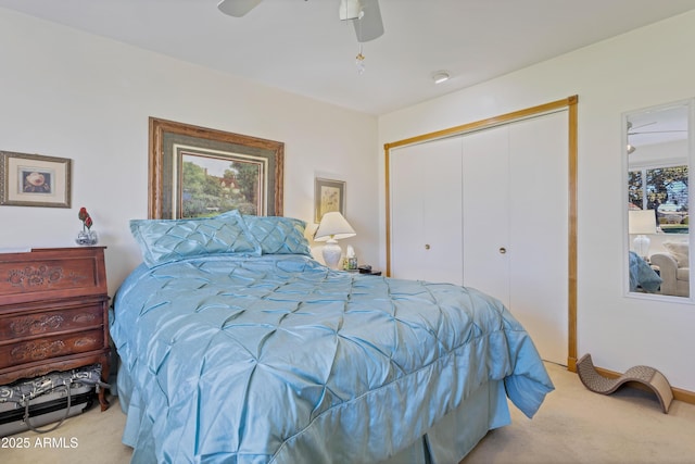 bedroom with ceiling fan, a closet, and light carpet