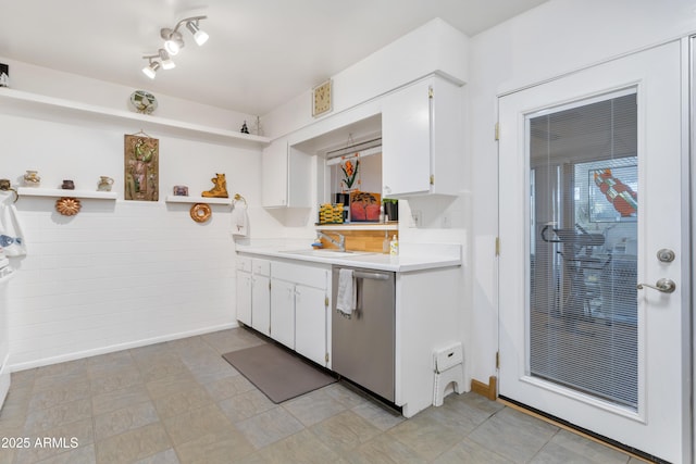 kitchen with sink, dishwasher, and white cabinetry