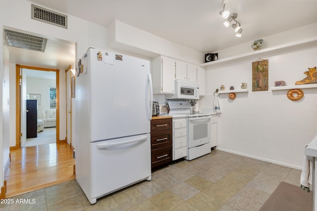 kitchen featuring white appliances, white cabinets, and light hardwood / wood-style flooring