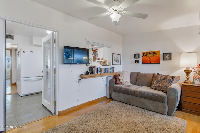 living room featuring ceiling fan and wood-type flooring