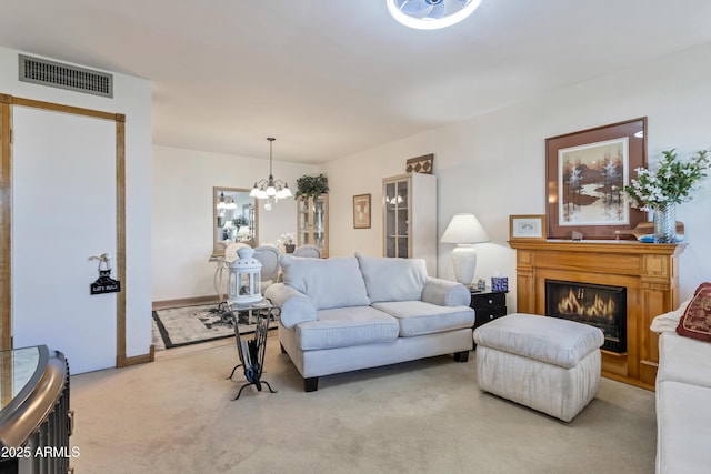 living room with a notable chandelier and light colored carpet