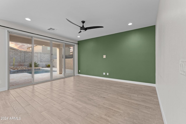 unfurnished room with light hardwood / wood-style flooring and ceiling fan