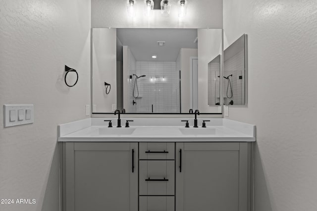 bathroom featuring vanity and tiled shower