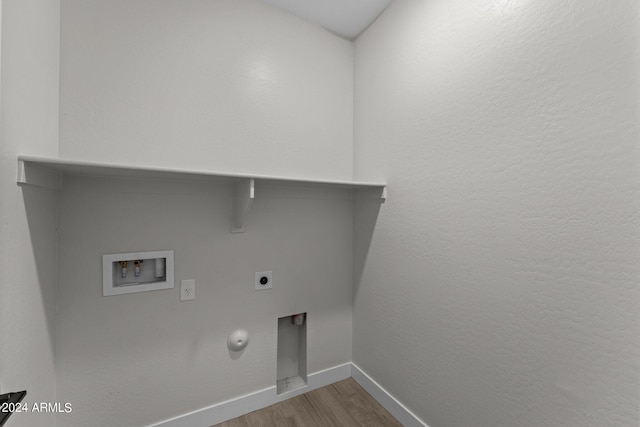 washroom featuring hookup for a washing machine, gas dryer hookup, wood-type flooring, and electric dryer hookup