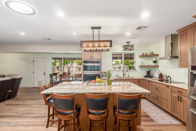 3136 W Sunnyside Ave, Phoenix, AZ 85029 - kitchen with double oven, sink, a kitchen breakfast bar, black electric stovetop, and wall chimney range hood