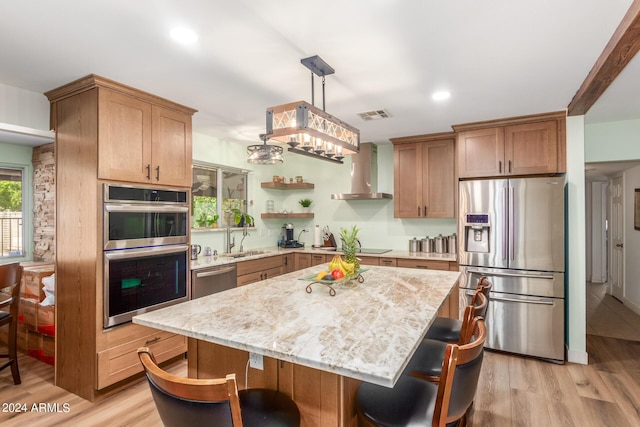 3136 W Sunnyside Ave, Phoenix, AZ 85029 - kitchen featuring sink, a center island, appliances with stainless steel finishes, pendant lighting, and wall chimney range hood