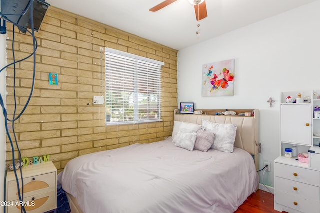 3136 W Sunnyside Ave, Phoenix, AZ 85029 - bedroom with ceiling fan, brick wall, and hardwood / wood-style floors