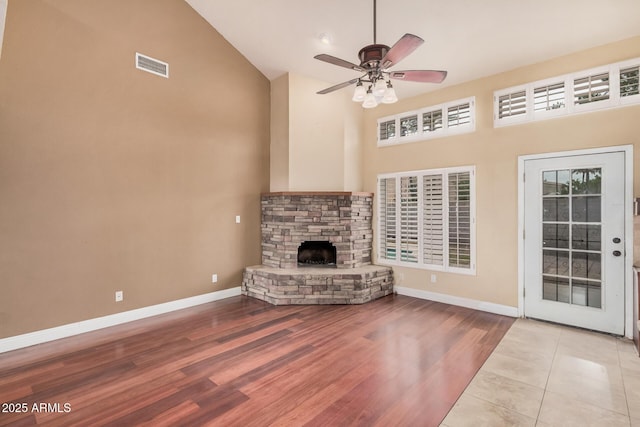 845 N Oak Ct, Chandler, AZ 85226 - unfurnished living room with high vaulted ceiling, baseboards, a fireplace, wood finished floors, and a ceiling fan