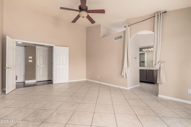 845 N Oak Ct, Chandler, AZ 85226 - spare room featuring a towering ceiling, a ceiling fan, light tile patterned floors, and baseboards