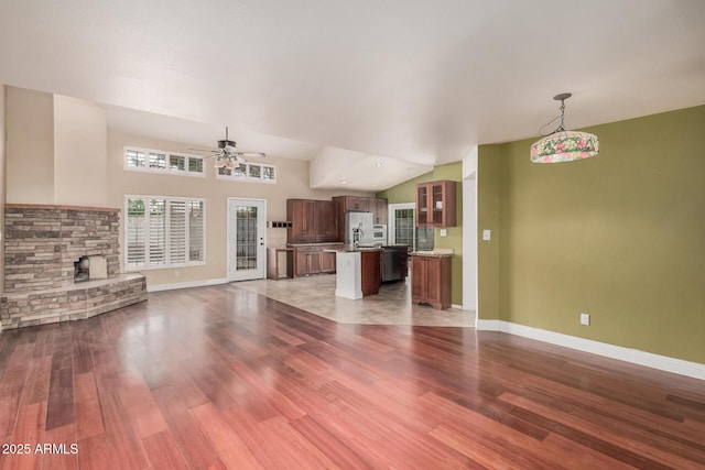 845 N Oak Ct, Chandler, AZ 85226 - unfurnished living room with wood finished floors, a ceiling fan, baseboards, and a fireplace
