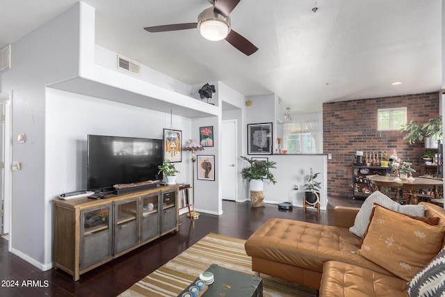 living room featuring ceiling fan, brick wall, and dark hardwood / wood-style floors