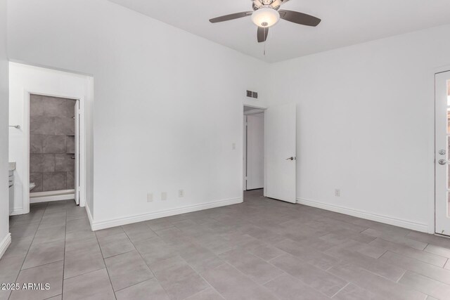 unfurnished bedroom featuring visible vents, vaulted ceiling, baseboards, and ensuite bathroom