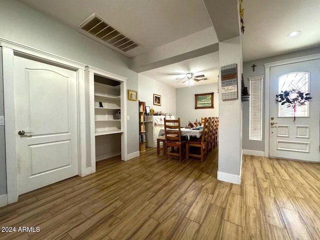 dining space with ceiling fan and light wood-type flooring