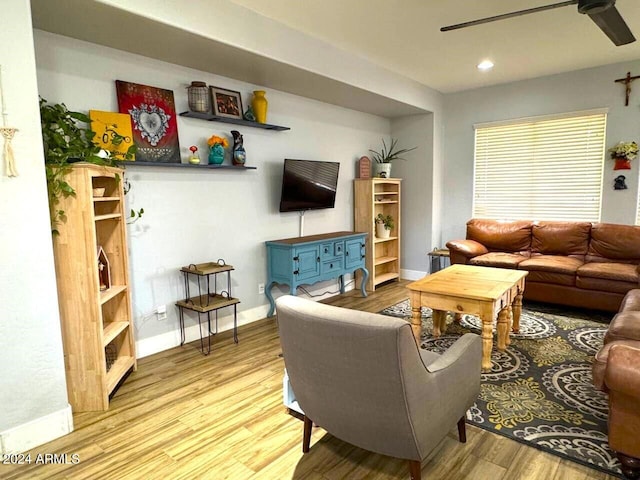 living room featuring light wood-type flooring and ceiling fan