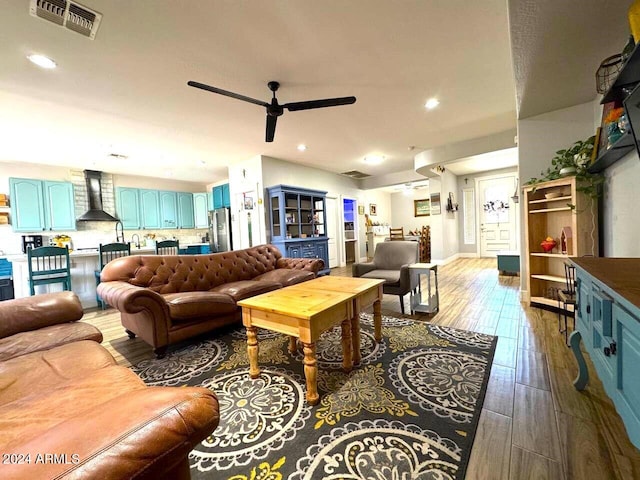 living room featuring hardwood / wood-style flooring and ceiling fan