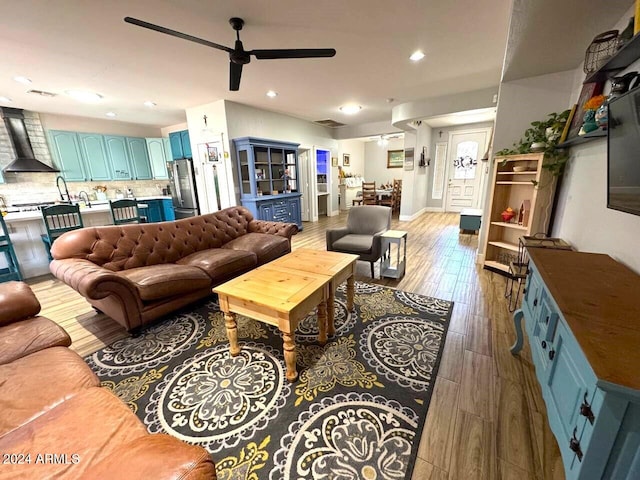 living room featuring hardwood / wood-style floors and ceiling fan