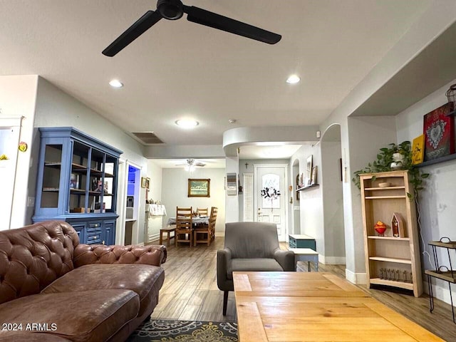 living room with light hardwood / wood-style flooring and ceiling fan